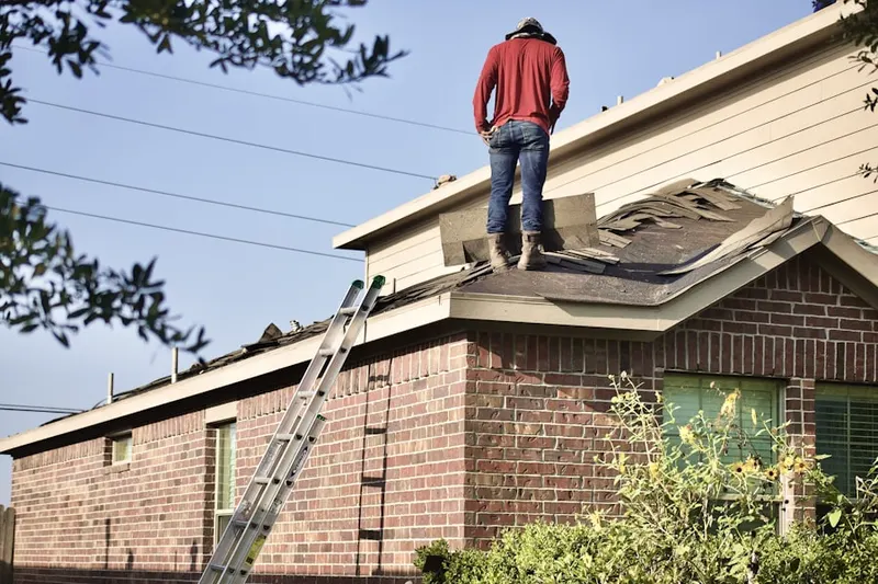 Professional roofer working on a residential roof in Valparaiso